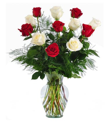 Red and white roses in a clear glass vase
