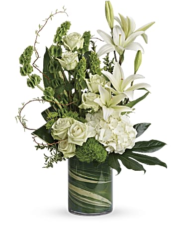 White lilies and roses in a green glass vase