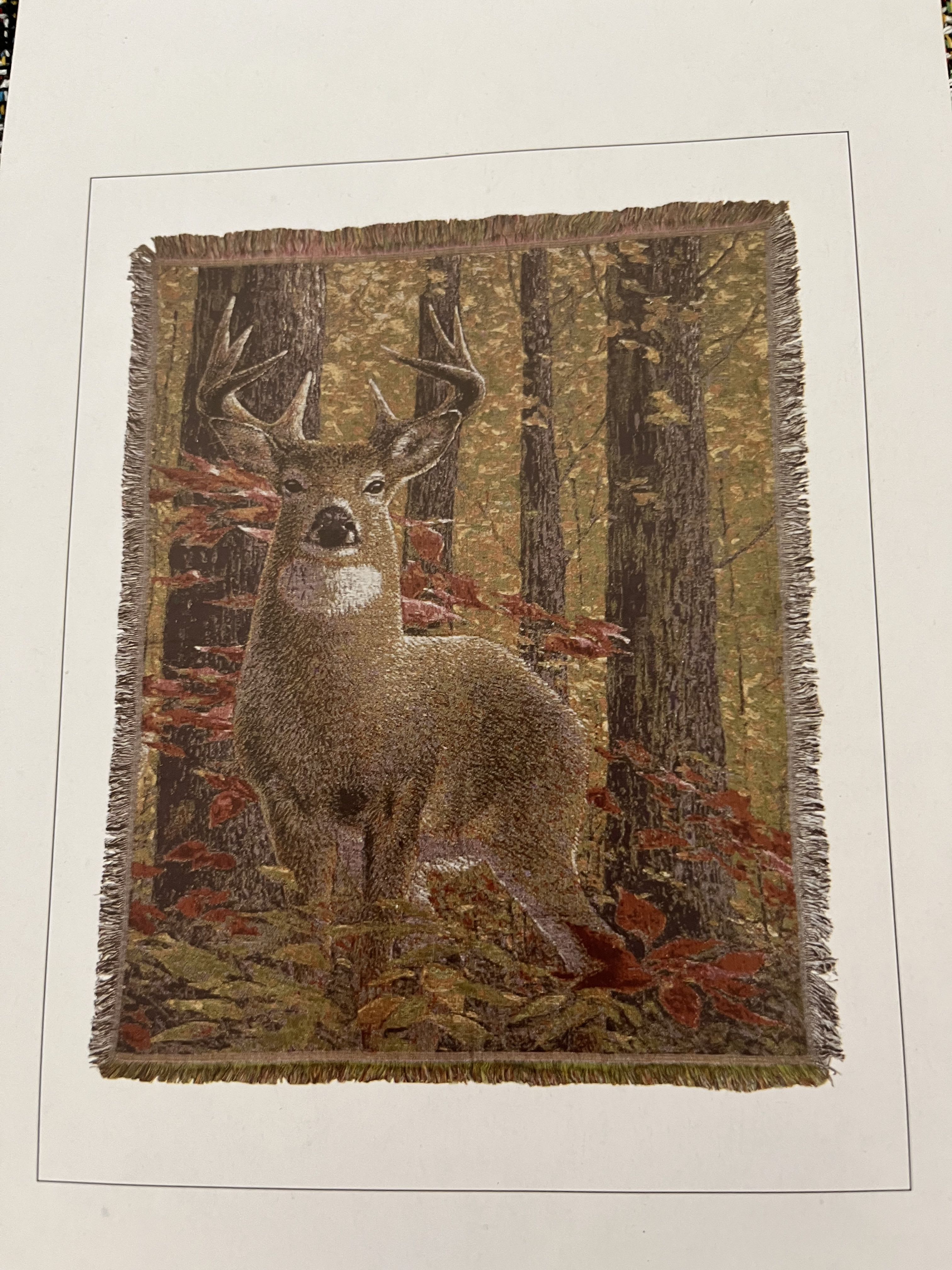 Fringed wall hanging with a deer in an autumn forest