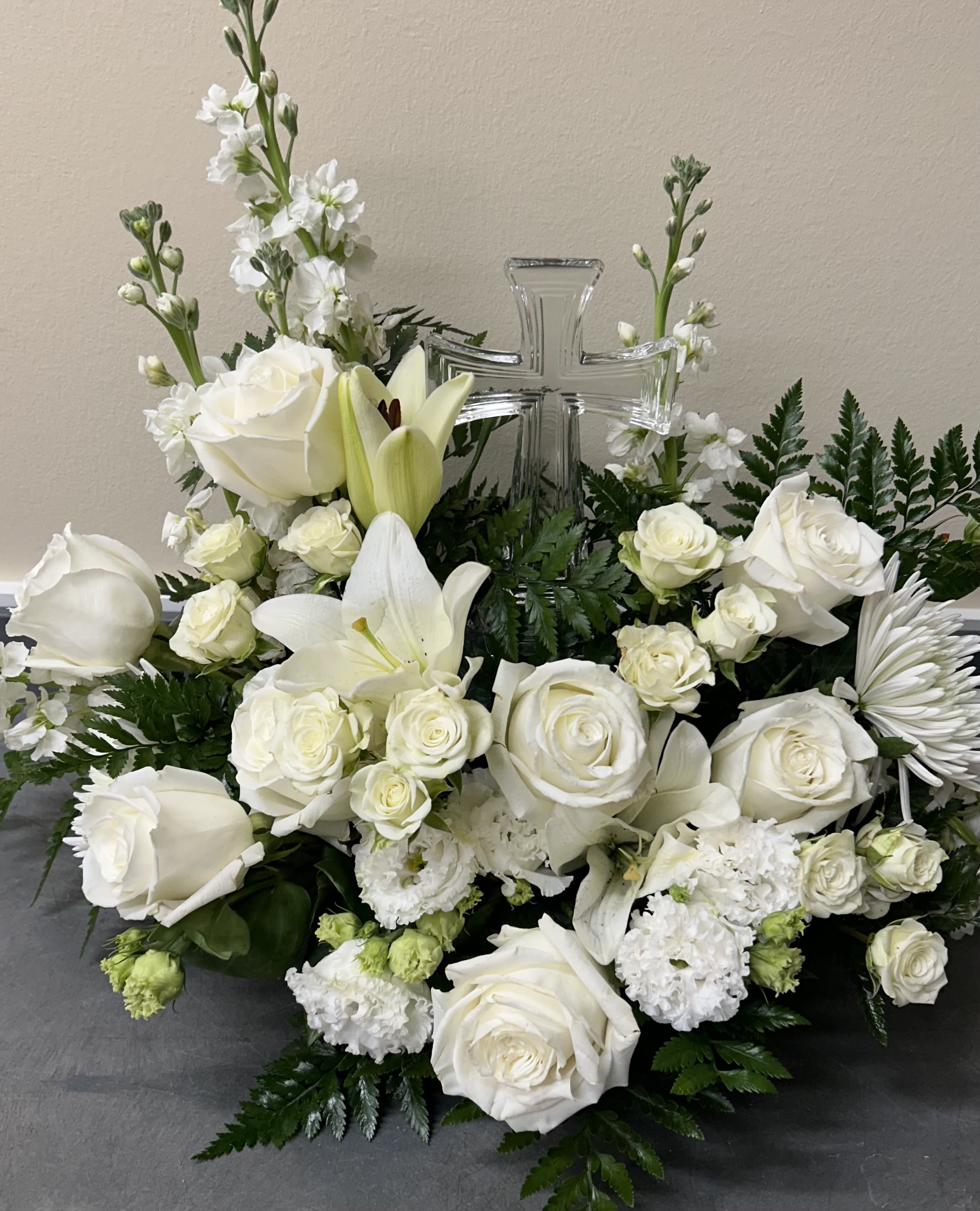 Glass Cross Arrangement - This glass cross is adorned in between the flowers