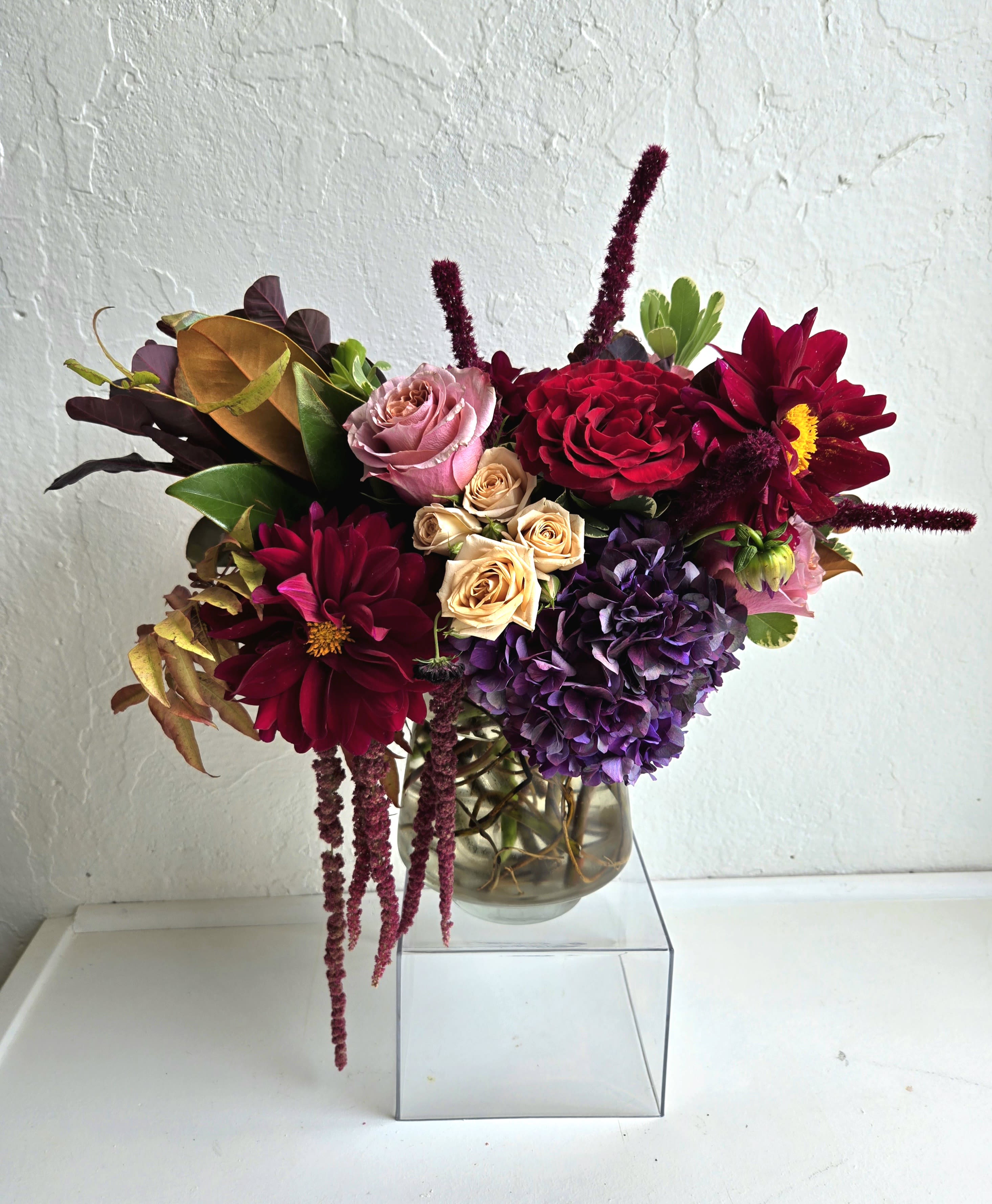 Bouquet of red, purple, and pink flowers in a glass vase