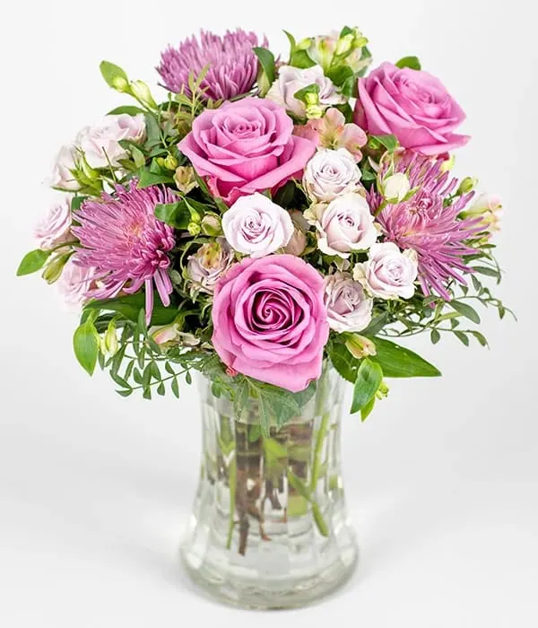 Pink &amp; Lilacs  bouquet  - A pretty pink and lilac bouquet feauturing roses, chrysanthemums, and alstroemeria, surrounded by mixed seasonal foliage