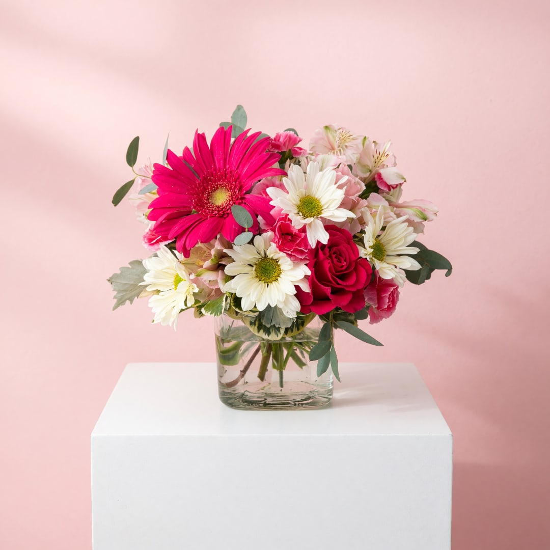 Pink and white mixed bouquet in a clear glass vase