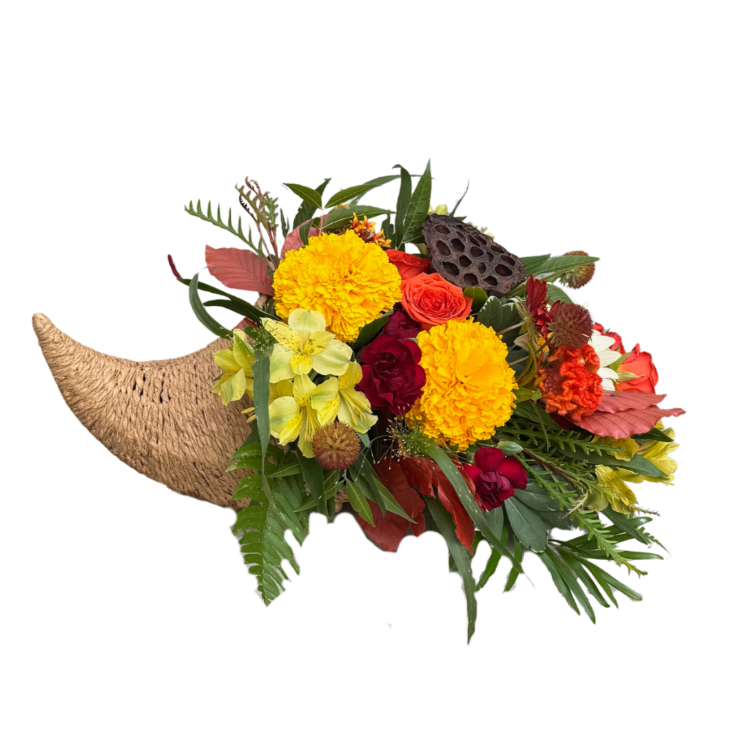 Tropical bouquet with yellow and orange flowers in a woven horn-shaped container