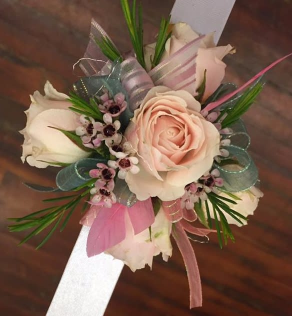 Corsage with pale pink roses and ribbon accents