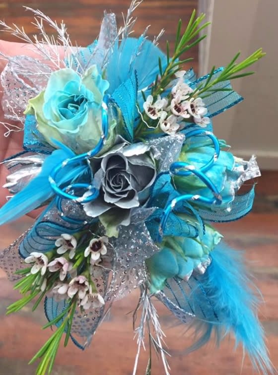 Blue and silver bouquet with roses and small white flowers