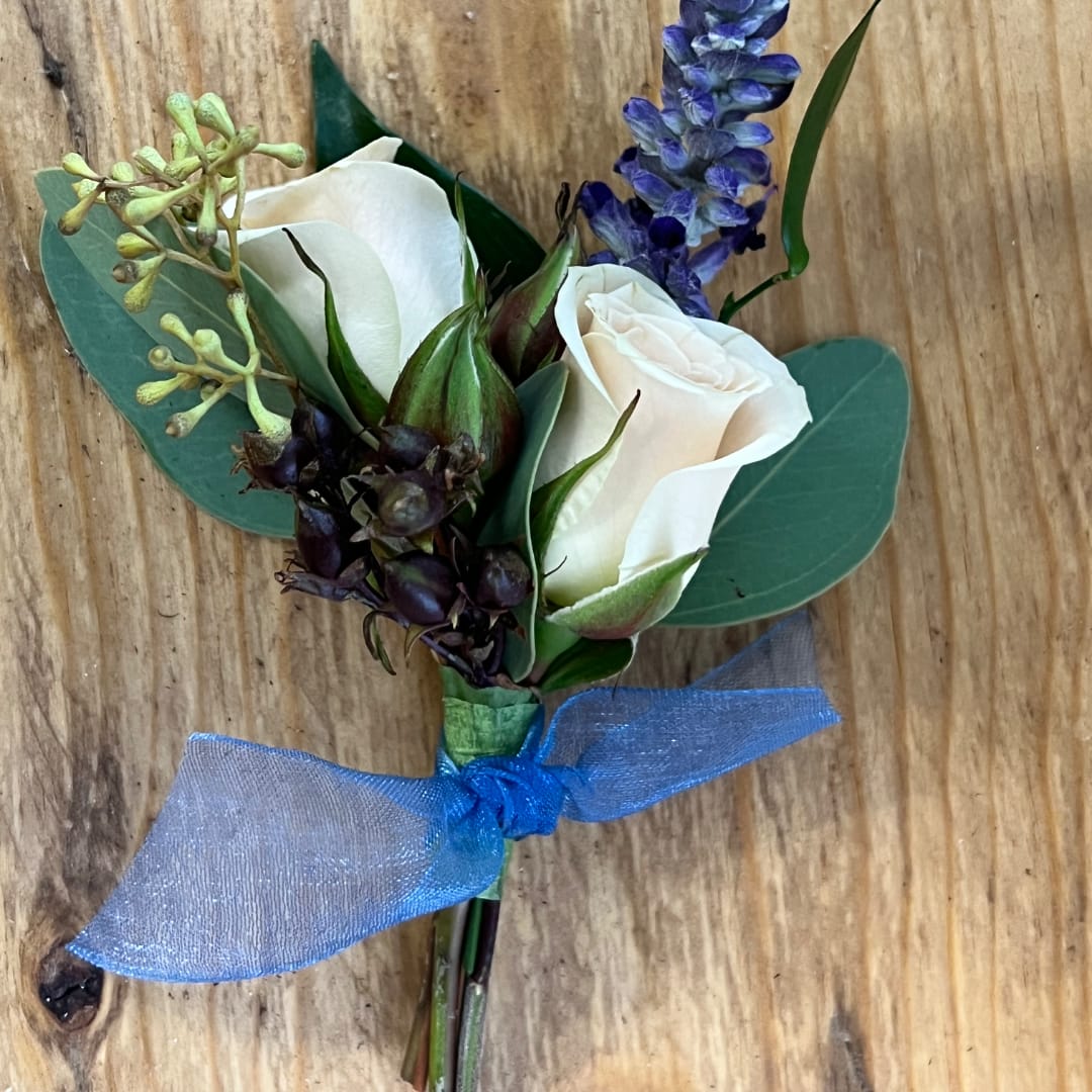 White rose boutonniere with blue ribbon and purple accent flower