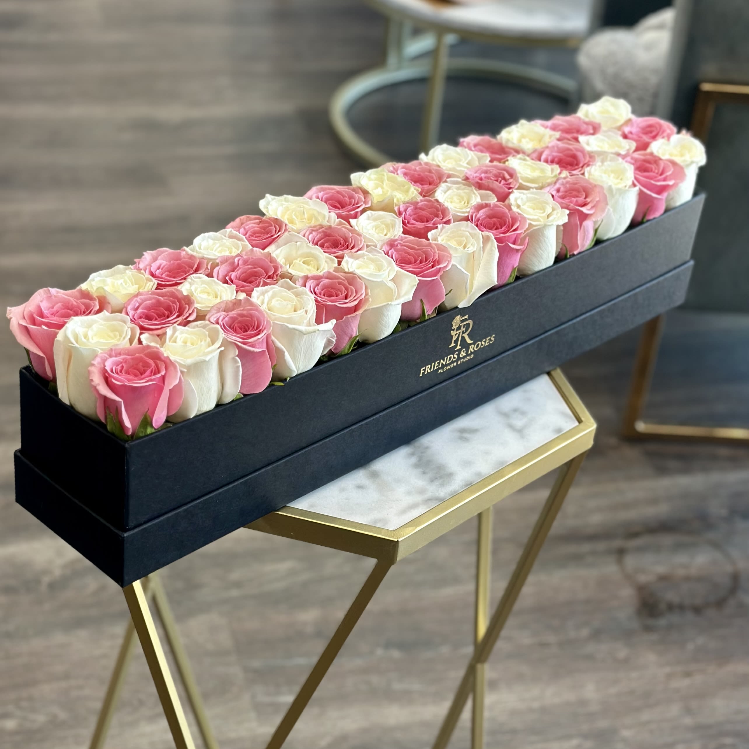 Sweet Rose - A timeless blend of elegance and romance. This beautiful arrangement features 42 pink and white roses carefully arranged in our black box. Soft blush tones paired with creamy white blooms create a graceful and sophisticated gift for any special occasion. Perfect for birthdays, anniversaries, Mother's Day, or simply to make someone feel loved.