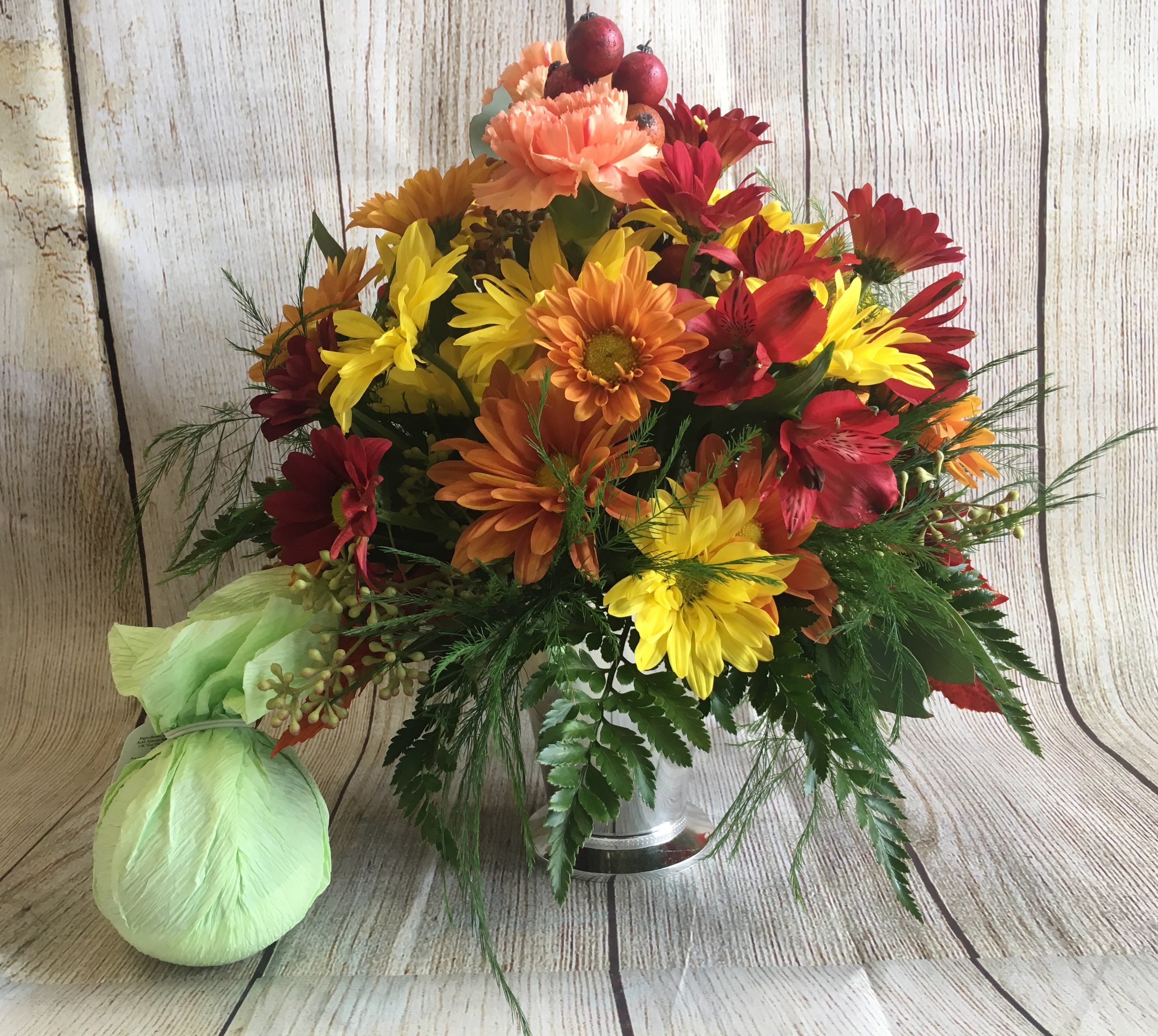 Autumn Delights - A cheerful assortment of autumn blooms in a posy container. Accompanied by a Musee bath balm, perfect for any occasion.  (All designs are arranged as similar as possible. We promise to keep the same color, style, and overall theme with what Mother Nature generously blesses us with)