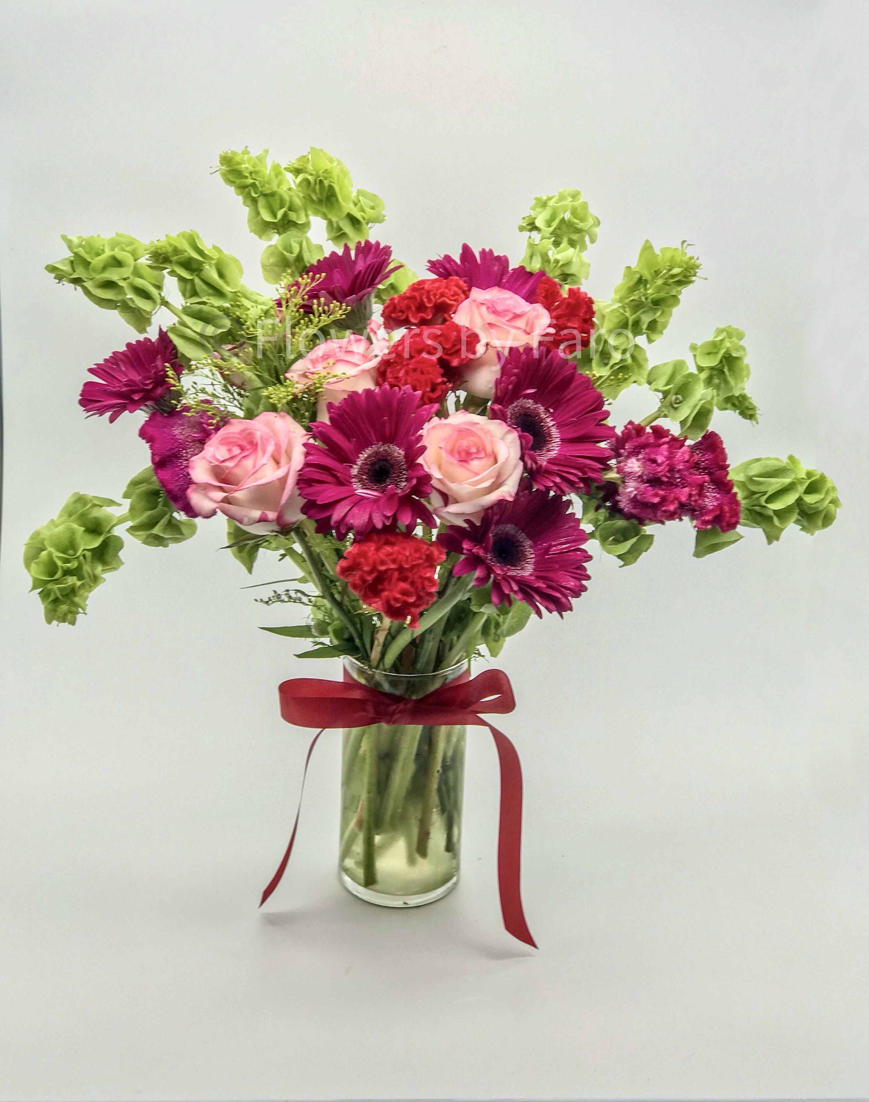 Pink Delight Bouquet - A radiant mix of rosy pinks and vivid florals accented with lush greens, designed to bring energy, warmth, and a festive touch to any occasion.