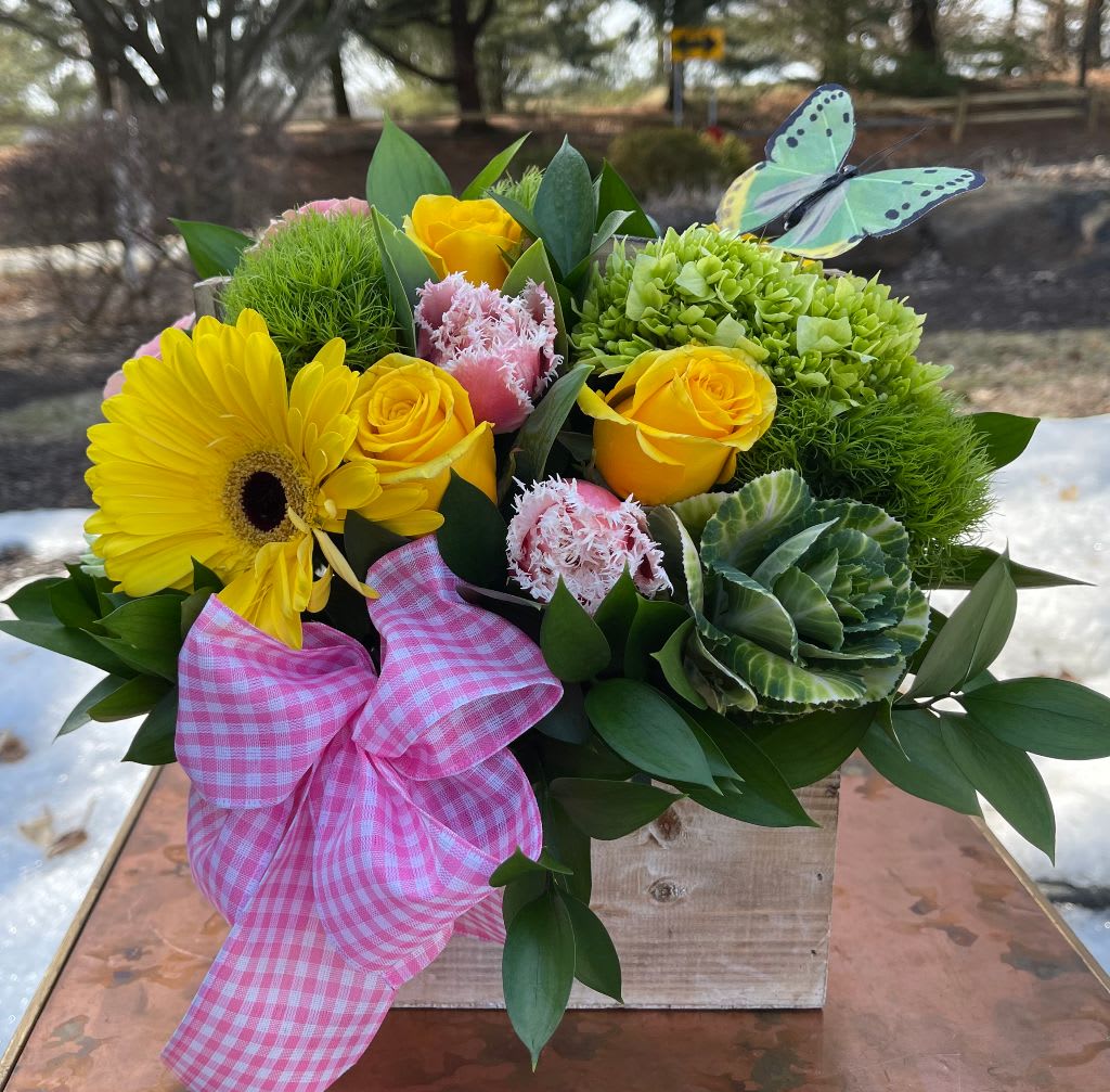 Gingham Pleasure - This adorable arrangement features yellow Gerber daisies, yellow roses, and green hydrangea with pink accents in a rustic wooden container. Tax free. Same day hand delivery.  We are a local florist in Wilmington, Delaware that provides the best delivery of fresh flowers on the same day. We also offer next day delivery. Our flower shop services the Wilmington and Newark Delaware areas as well as south eastern PA. We are a flower shop near you that is tax free and provides hand delivered flowers. We offer funeral, sympathy, anniversary, birthday, holiday, Mother's Day, Valentine's Day and rose arrangements and flowers for all occasions. Petals is a full service florist that offers the best online flowers and fresh flower arrangements. You can send flowers from our flower shop to Wilmington, New Castle, Newark, Hockessin, Chadds Ford, Kennett Square and other local cities near us. 