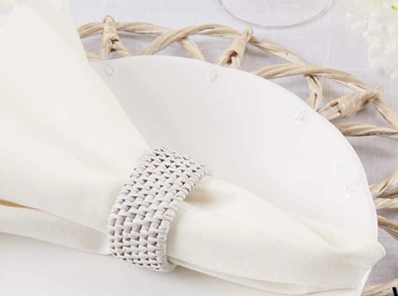 White napkin with a woven ring on a wicker placemat
