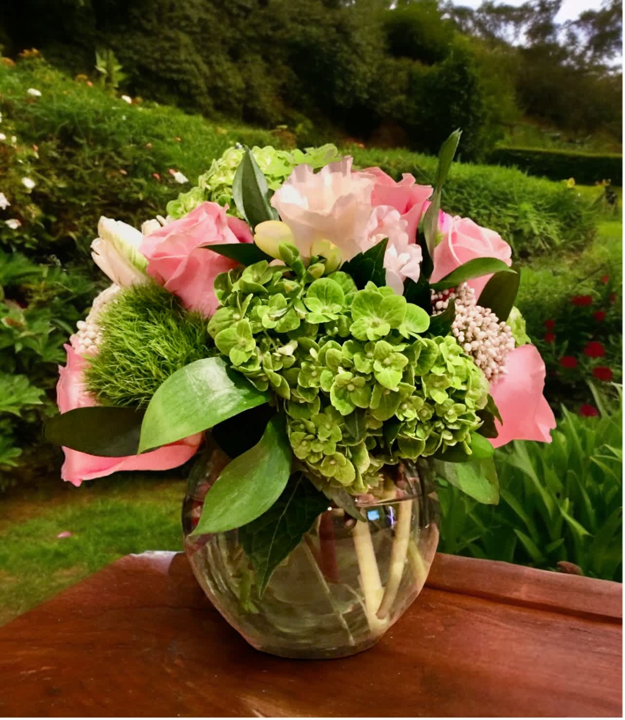 Pop of Pink - Pop of Pink Brighten any day with Pop of Pink, a cheerful floral arrangement handcrafted by Petals Flowers and Fine Gifts, your premier local florist in Wilmington, Delaware. This fresh, uplifting design features soft light pink roses, vibrant green hydrangea, playful green trichelium, and delicate blush pink accent flowers, all elegantly arranged in a clear glass vase to let the natural beauty shine.  Perfect for birthdays, anniversaries, new beginnings, or simply to say “thinking of you,” Pop of Pink brings a delightful mix of color and texture that’s sure to make someone smile. Its soft pinks and lively greens create a modern, stylish look that fits beautifully in any home or office.  Why Choose Petals Flowers and Fine Gifts in Wilmington, DE?  * We are a boutique flower shop located in Wilmington, Delaware, specializing in premium, custom floral arrangements with an artistic touch. * Offering same-day flower delivery throughout Wilmington, Hockessin, Newark, Chadds Ford, Kennett Square, and surrounding areas. * Enjoy tax-free shopping, exceptional service, and our satisfaction guarantee with every order. Order Pop of Pink today and let Wilmington’s favorite local florist help you celebrate life’s special moments with flowers that make a lasting impression.
