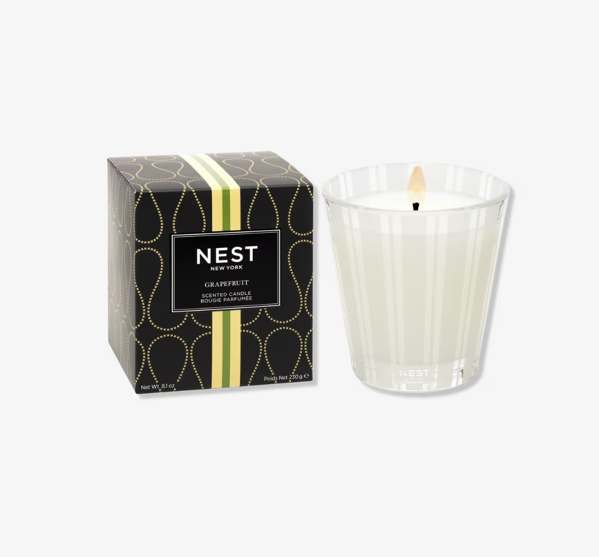 Scented candle in a glass tumbler beside its box
