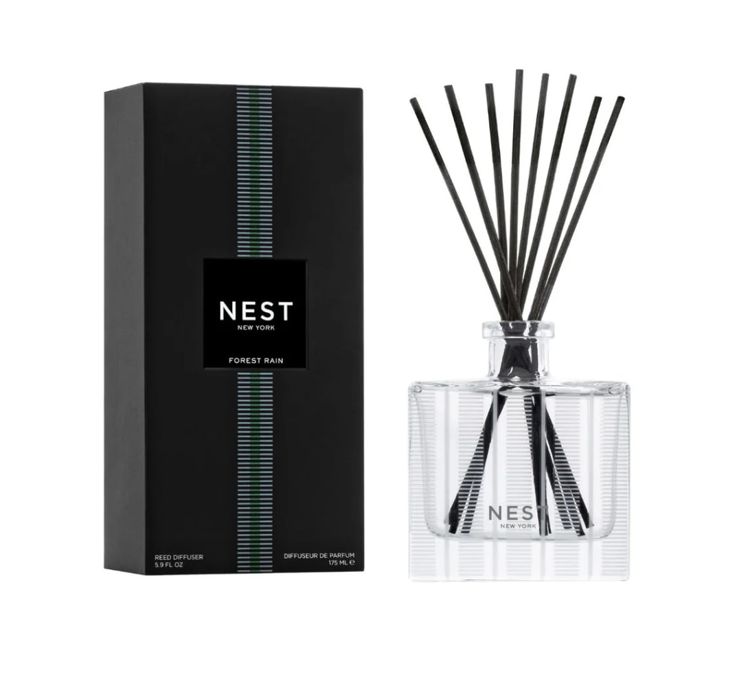 Reed diffuser set with a black box and clear glass bottle