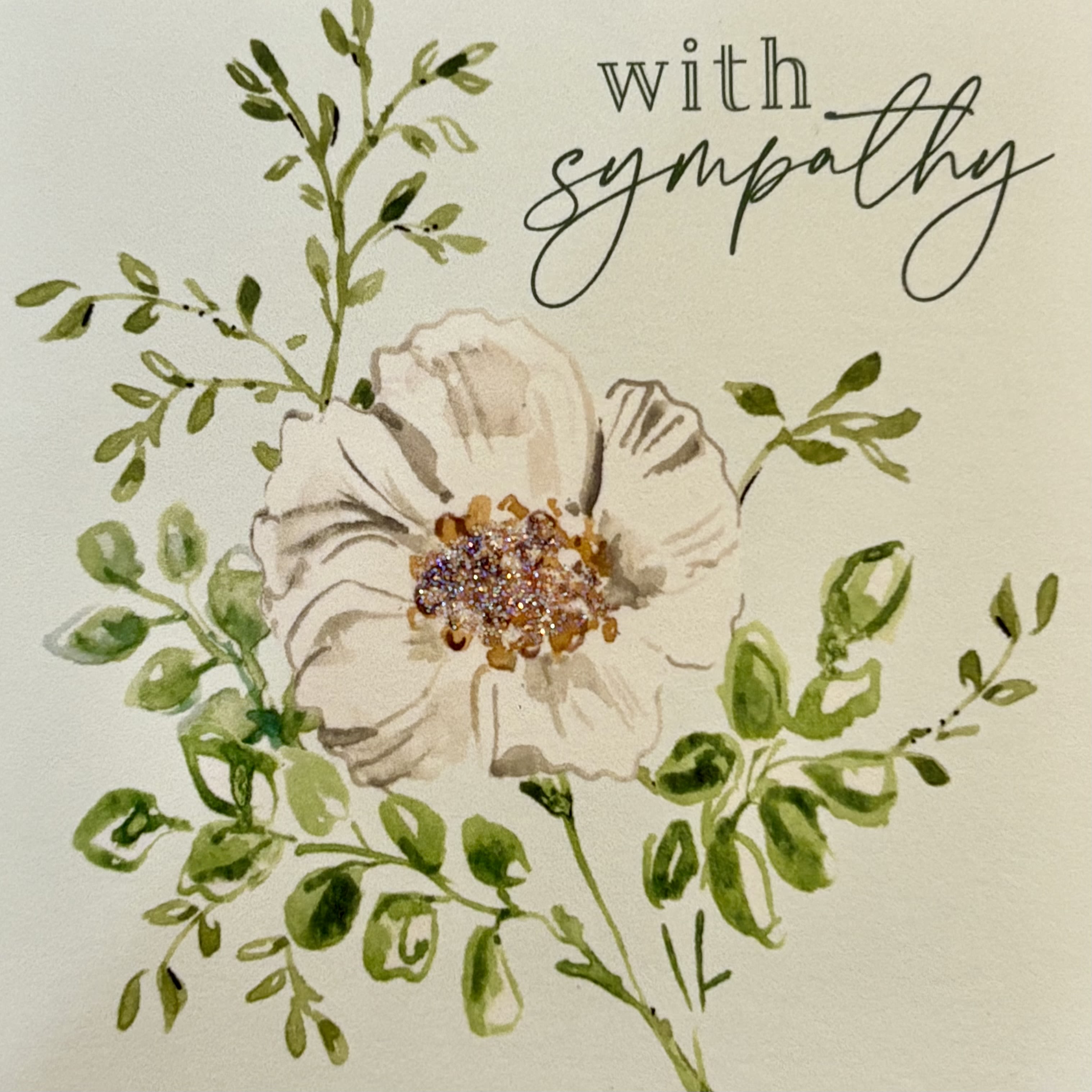 With Sympathy (Flower) Enclosure Card - Sympathy enclosure card featuring a white flower with greenery. A special touch to add to any arrangement. Inside in blank to include your personal sentiment.   Shop the best gift items in Wilmington, Delaware at your local florist and gift shop. From fresh floral arrangements and gourmet treats to unique seasonal décor and thoughtful gifts for any occasion, we offer carefully curated selections to delight your loved ones. Perfect for birthdays, anniversaries, holidays, or special celebrations, each gift is crafted with quality and care. Enjoy same-day delivery in Wilmington, DE, and surrounding areas, making it easy to send joy, love, and celebration right to their doorstep.