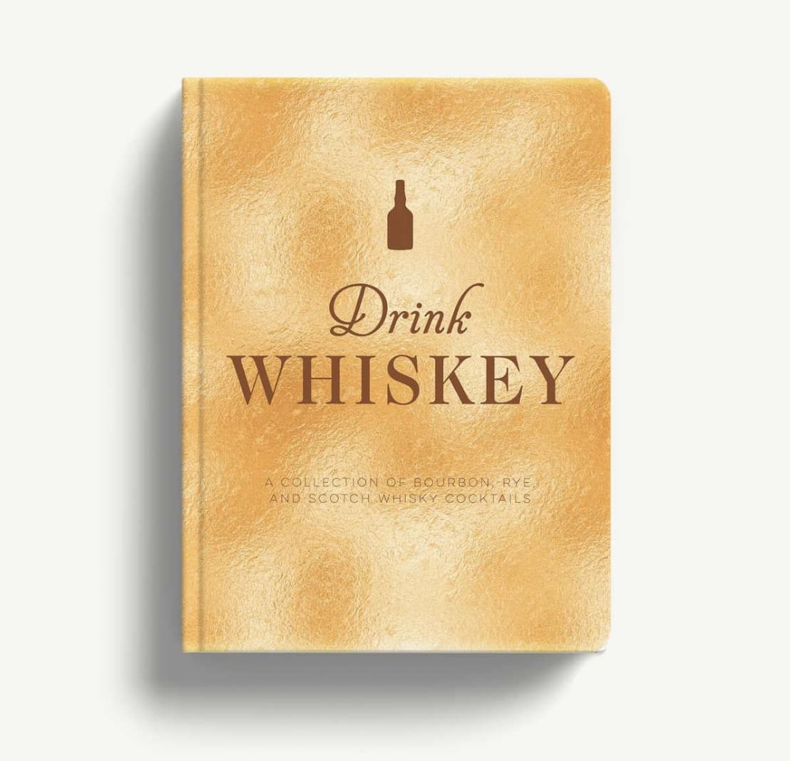 Gold book titled Drink Whiskey on a white background
