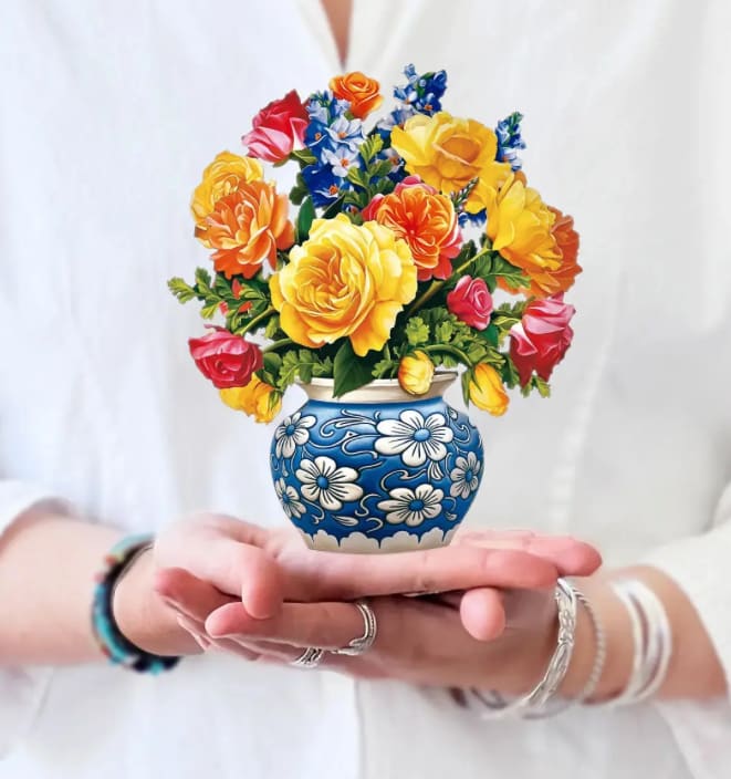 Colorful bouquet of roses in a blue floral vase