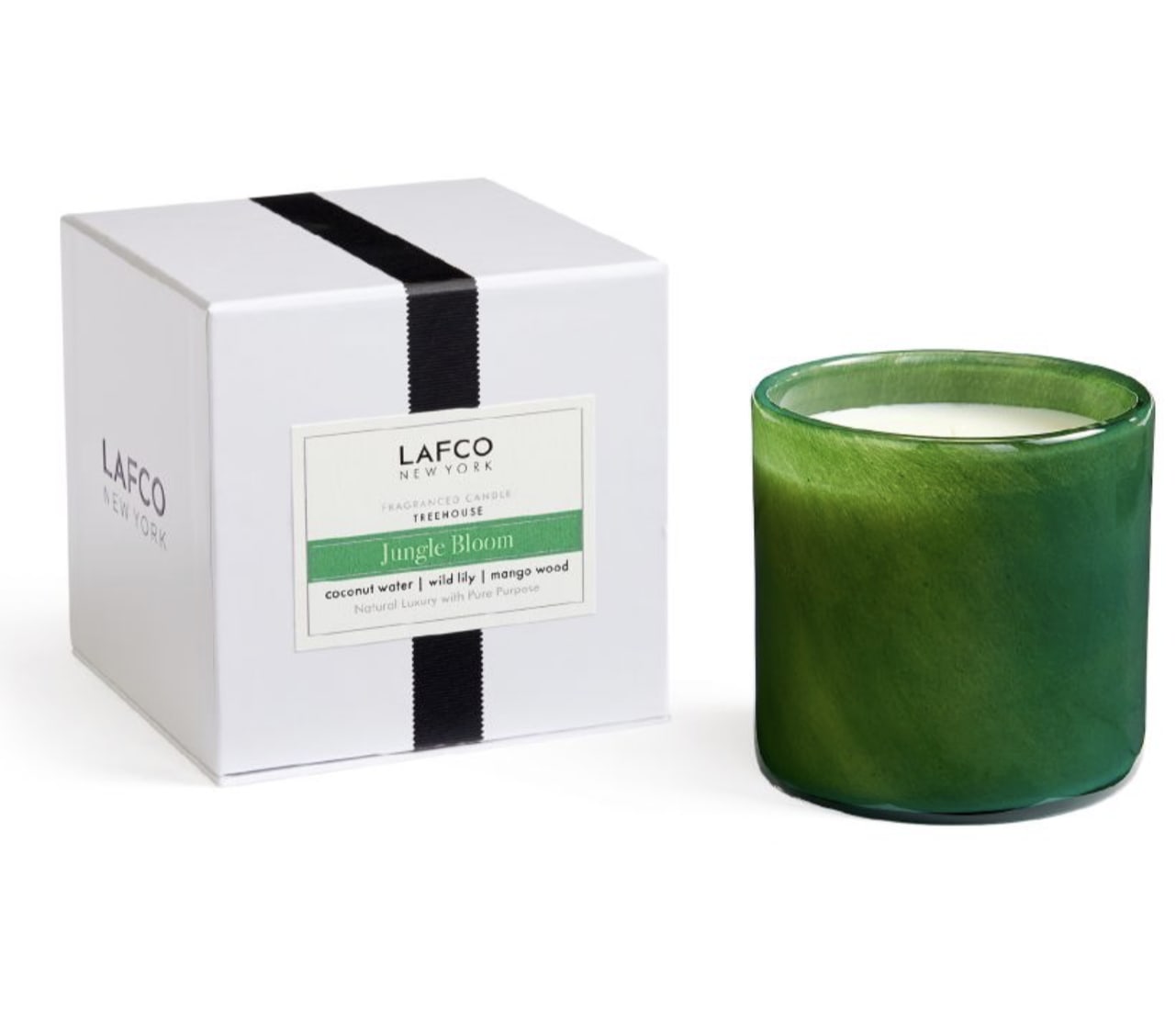 Green scented candle in a glass jar beside its white box