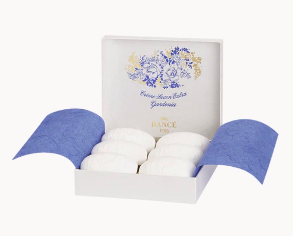 Box of white soaps with blue floral packaging