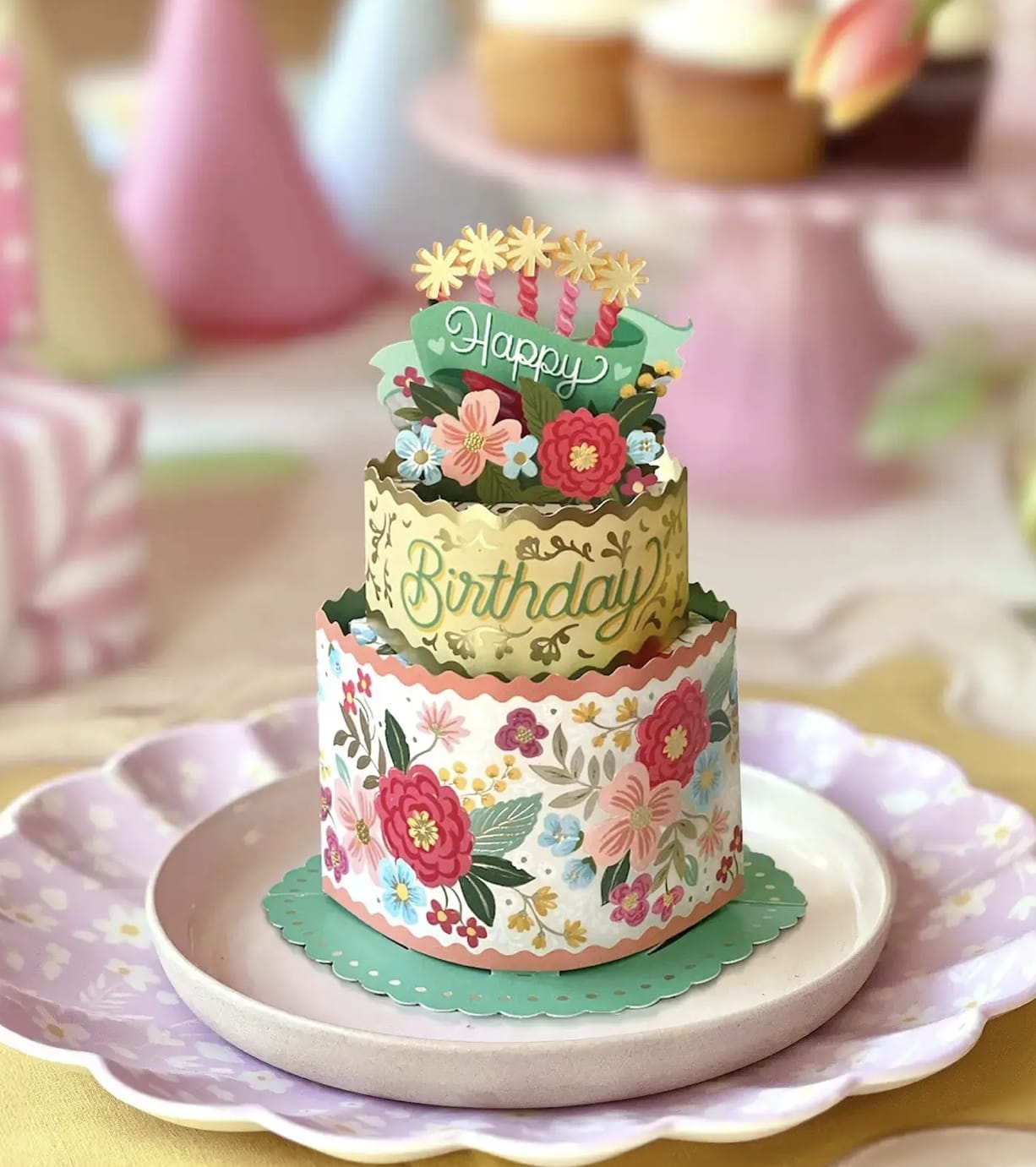 Tiered birthday card with floral decorations on a plate