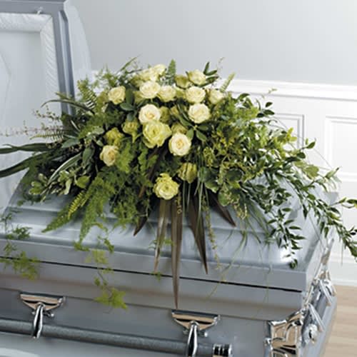White rose casket spray with trailing greenery