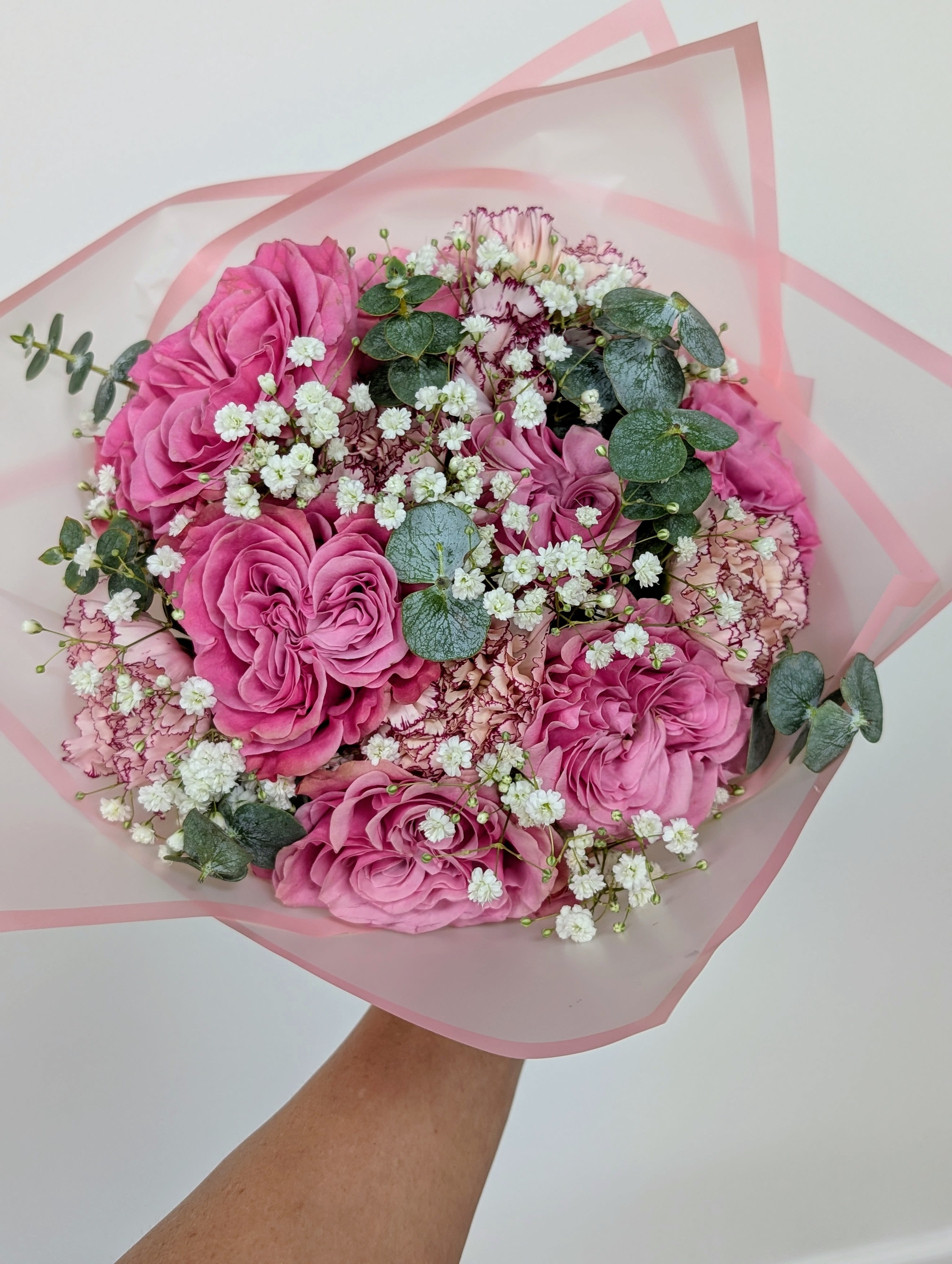 Pink rose bouquet with white baby's breath and eucalyptus in pink wrap