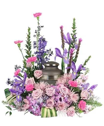 Lavender and pink floral arrangement around a metal urn