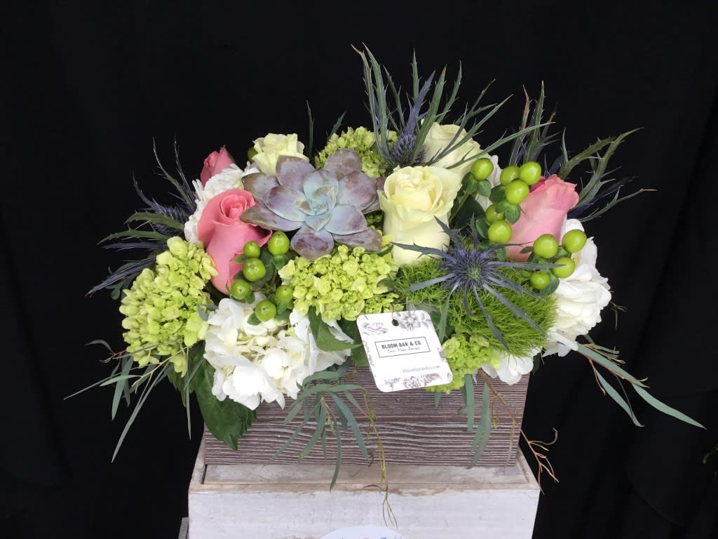 The French 75 - This vintage style arrangement contains roses, hydrangea, and a succulent. Arranged in a rustic wood box, this design is the perfect mix of classy and down-to-earth.