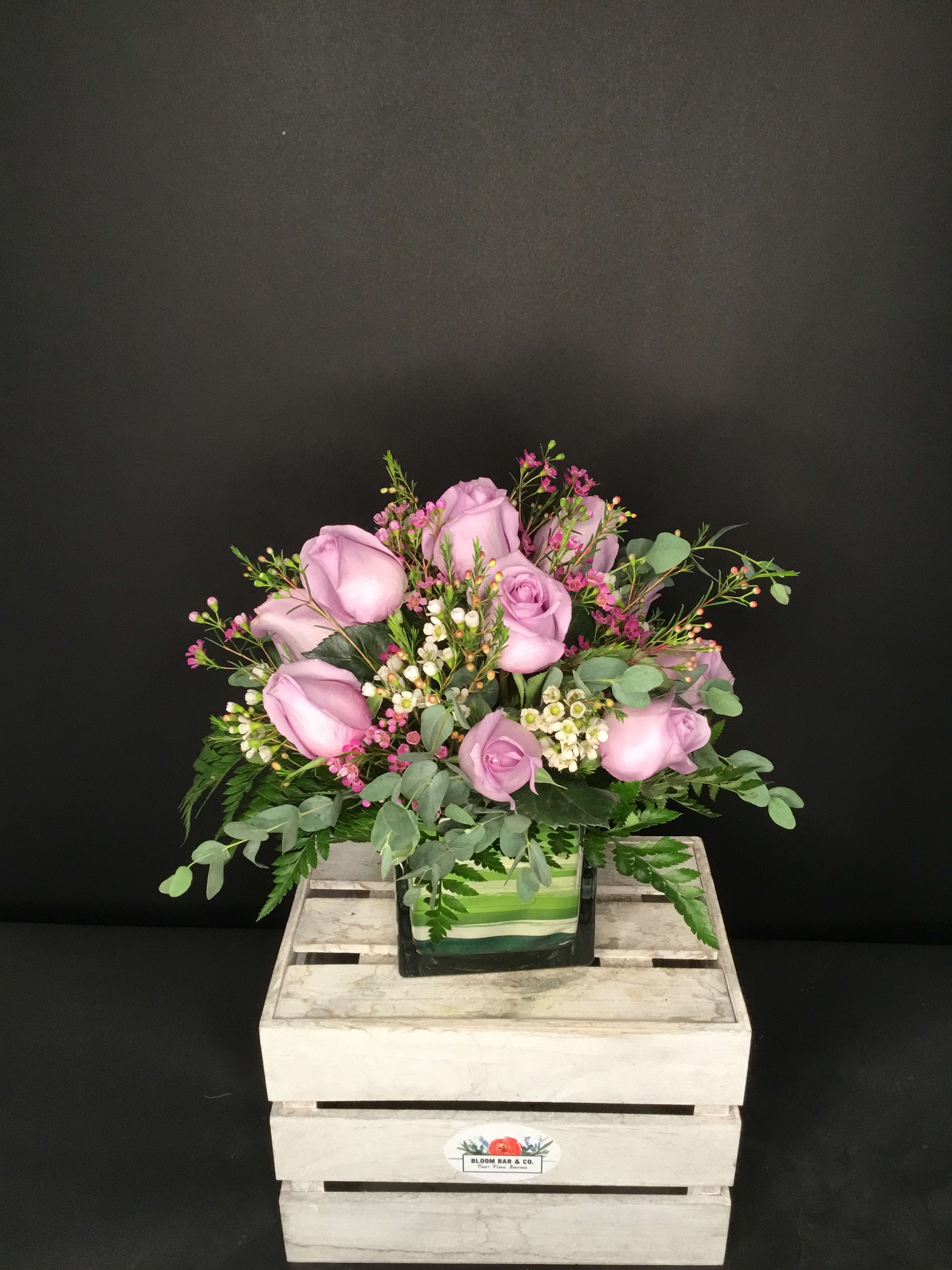 The Purple Passion - Sweet lavender roses give this lovely design an understated charm. While not as common as red or pink roses, they're sure to please the purple-lover in your life!