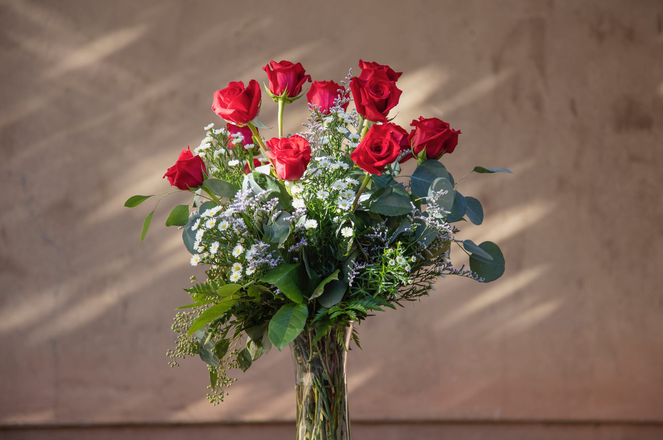 The Old Fashioned (1, 2, or 3 dozen roses) - A design of roses is always perfect, always appreciated! We add even more charming beauty with mixed eucalyptus and filler. Available in red, pink, yellow, white, lavender, or Valentine's mix!  Upgrades bring an extra dozen roses and more exotic greens!  ***Please specify color. If you do not, we will send something fresh and appropriate for the occasion, depending on availability***