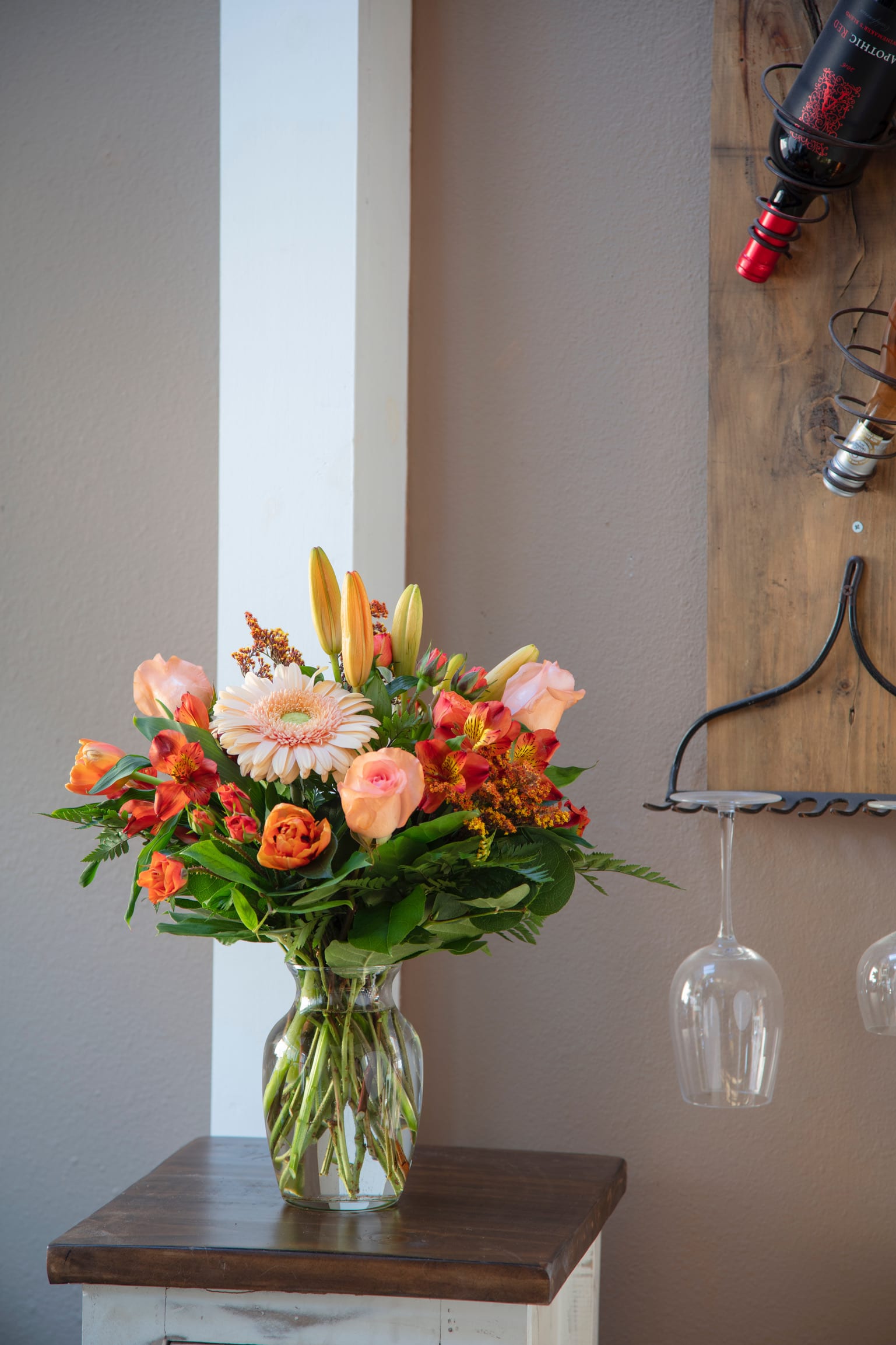 The Georgia Peach - What’s pretty in peach? This rich mix of orange, peach, and ivory blooms adds a warm glow to any setting. Includes lilies, roses, gerbera daisies, and stock