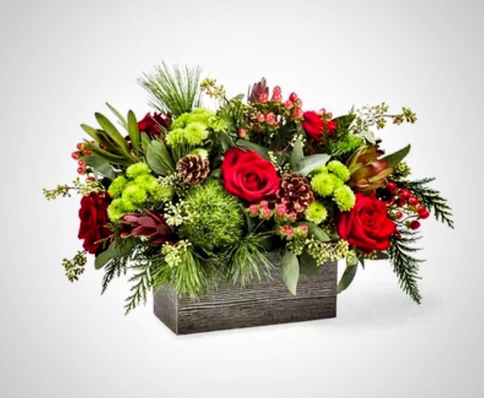 Red roses and green flowers in a rectangular wooden box