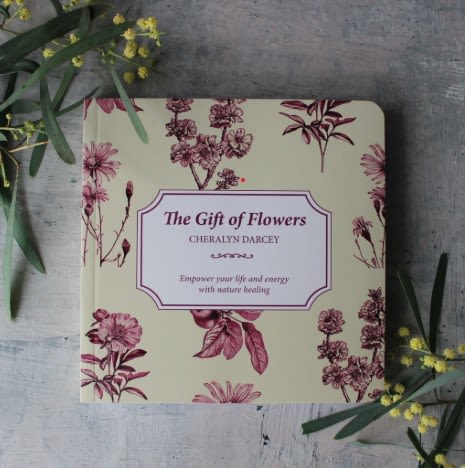 Floral-patterned book titled "The Gift of Flowers" on a gray surface