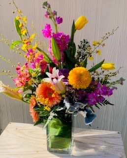 Ecsatic  - Airy design with  high end flowers including orchids and snaps and tulips.