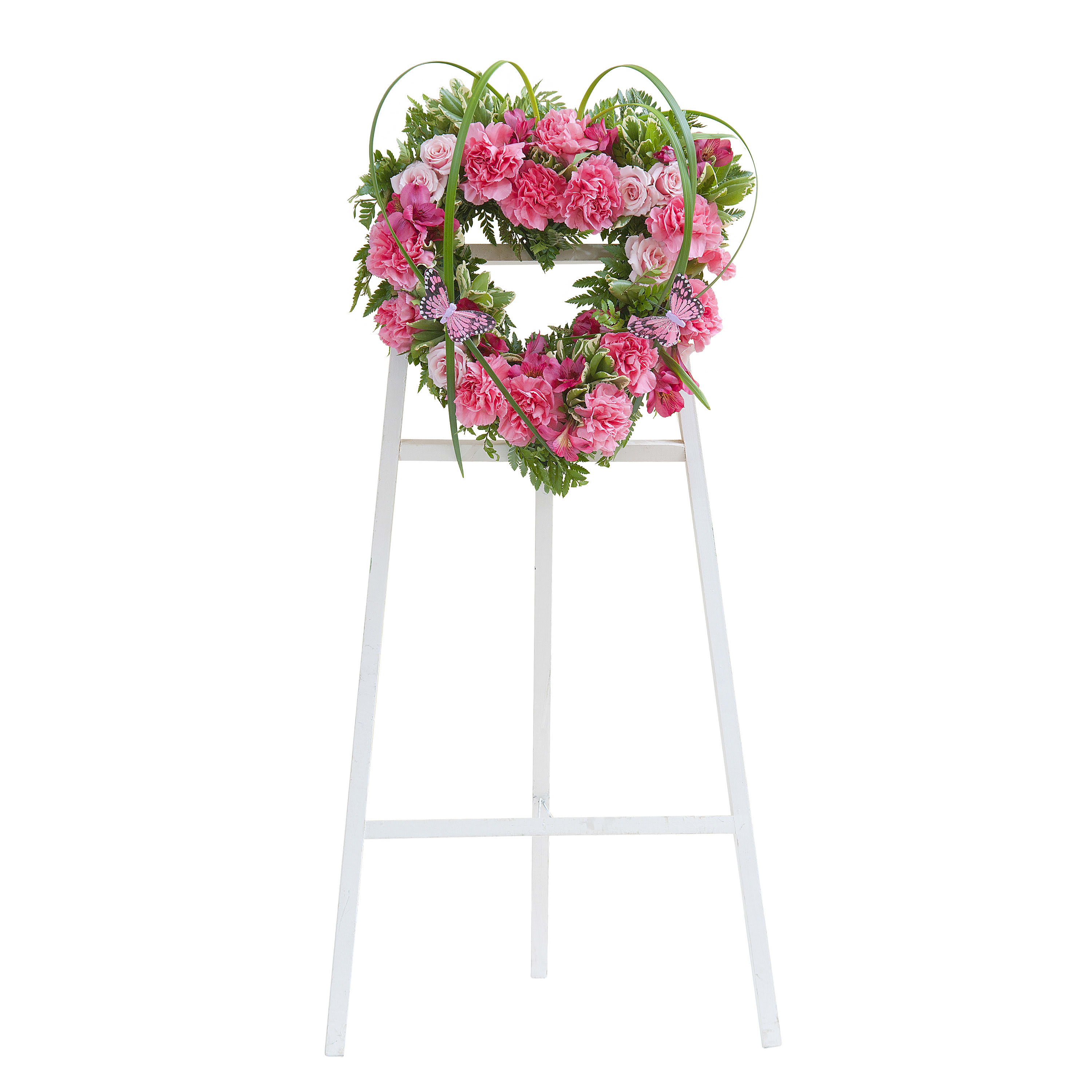 Pink floral wreath on a white standing easel
