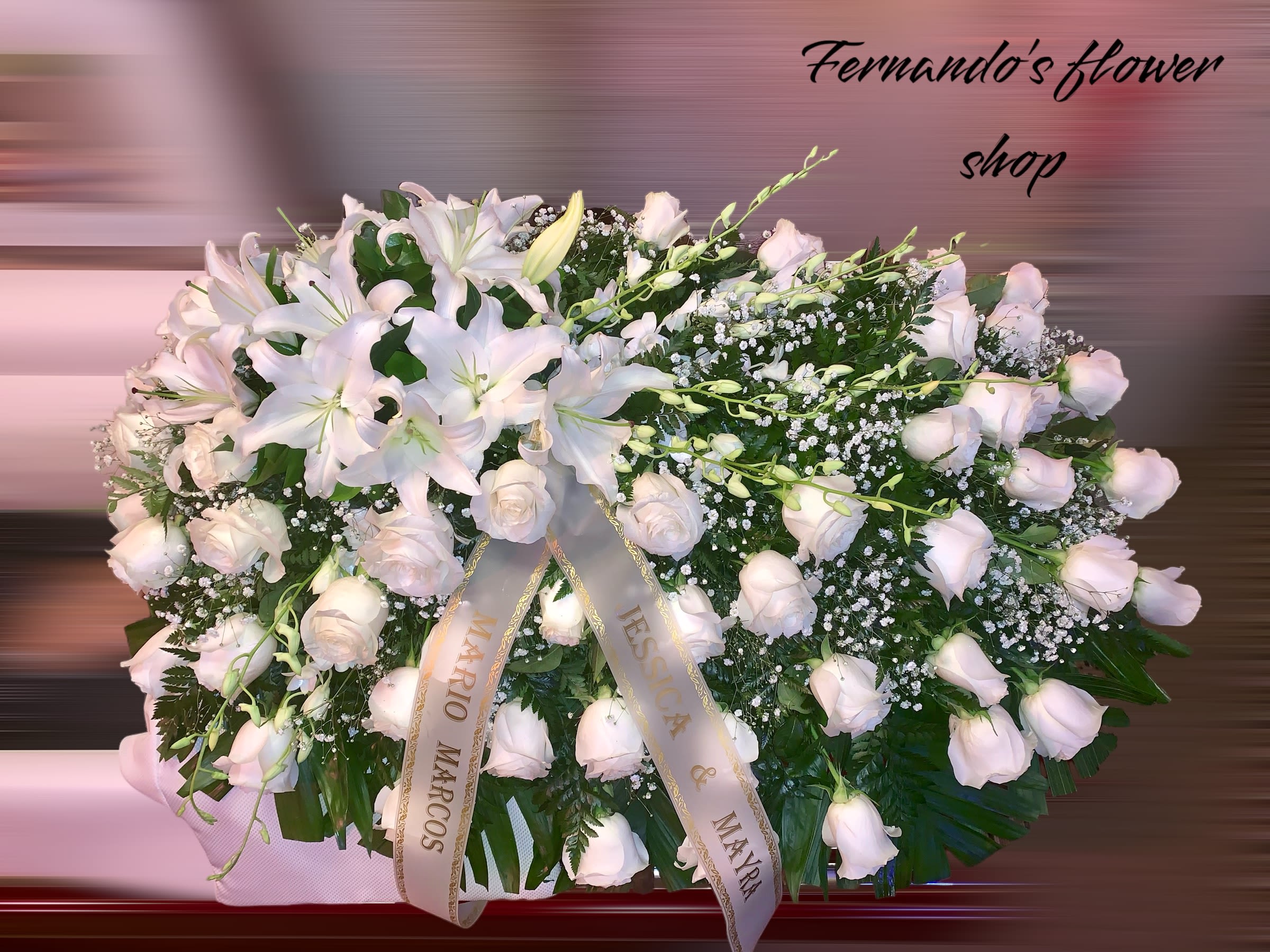 Large white lily and rose casket spray with memorial ribbons