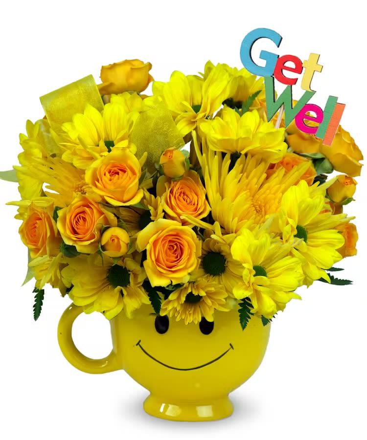 Yellow roses and daisies in a yellow smiley-face mug with a colorful Get Well pick