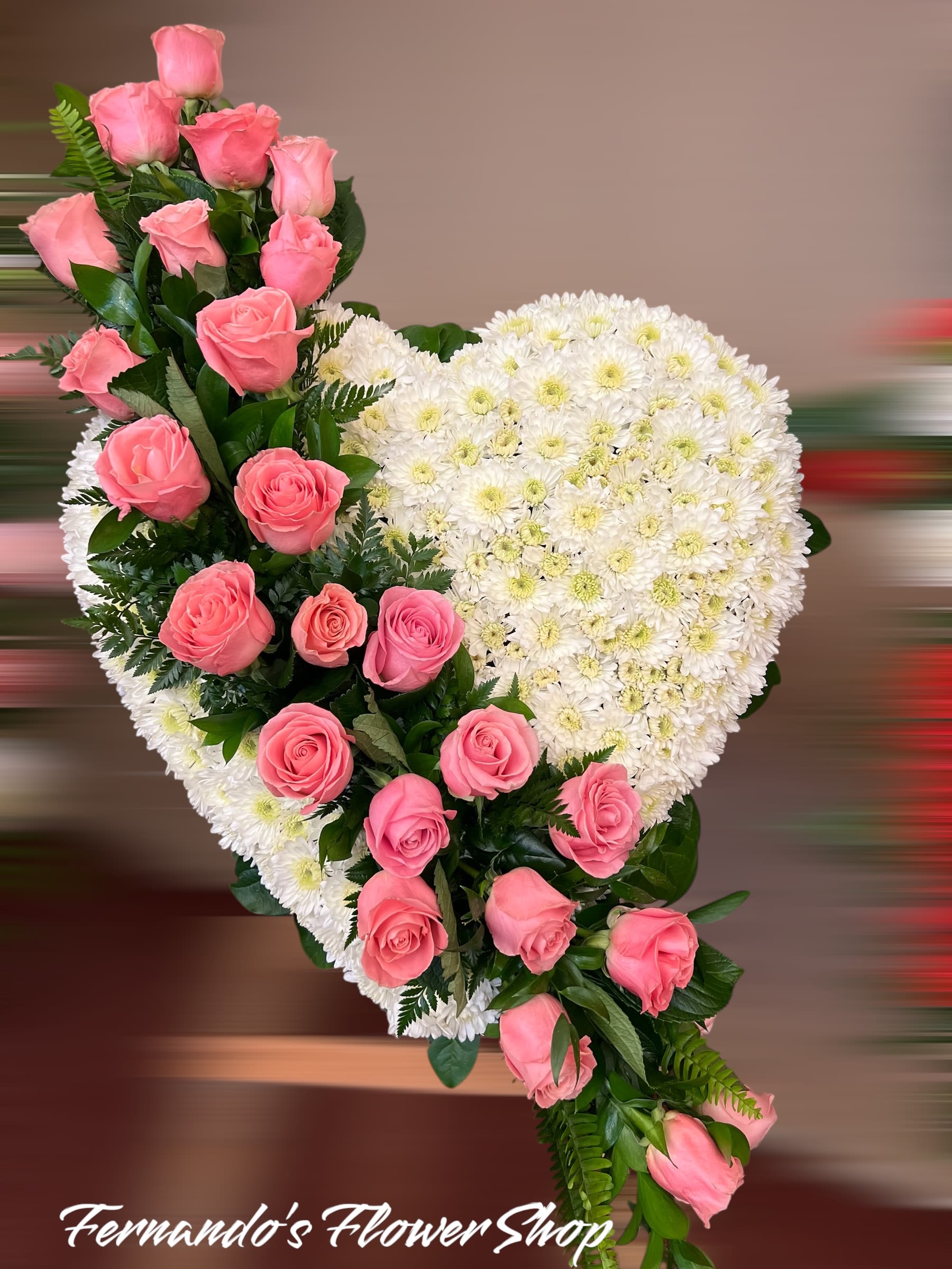 Heart-shaped standing spray of white mums with cascading pink roses on one side