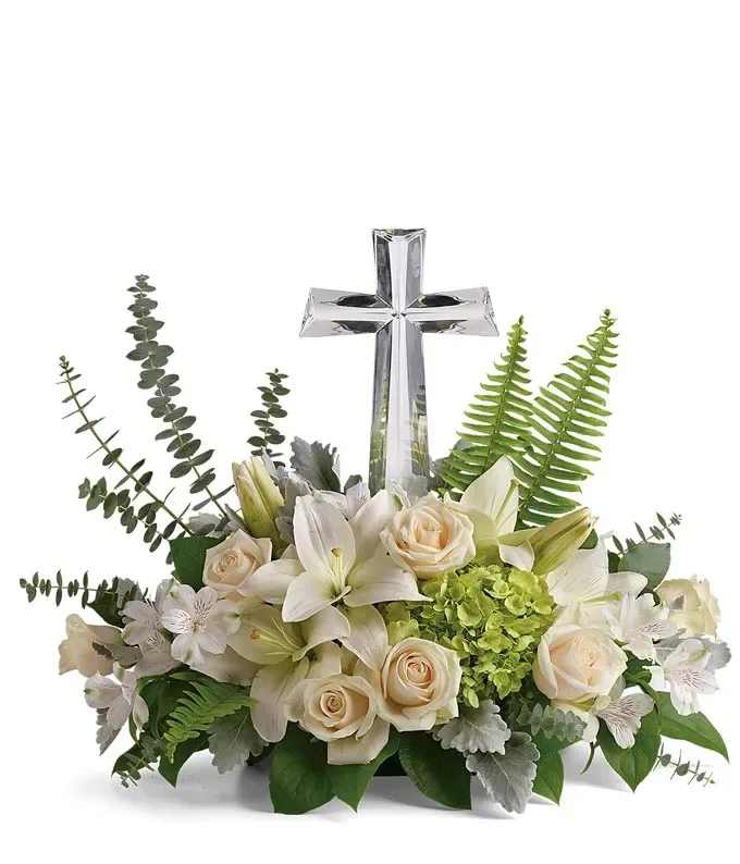 Low white and cream flower arrangement with crystal cross centerpiece and green accents