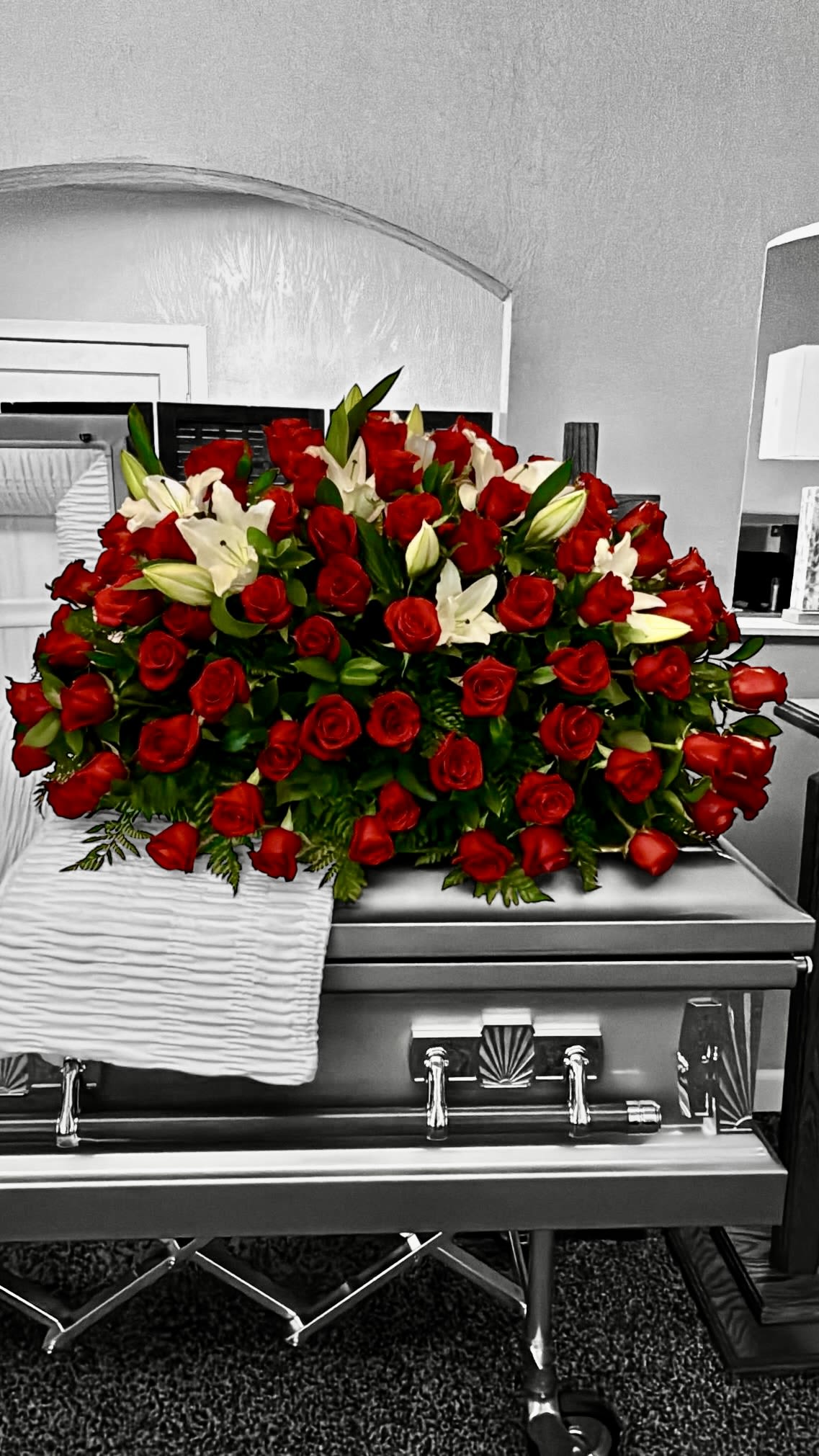 My last Tears - A touching farewell tribute featuring a lush casket spray of vibrant red roses and elegant white lilies. This arrangement conveys deep love, respect, and everlasting remembering.