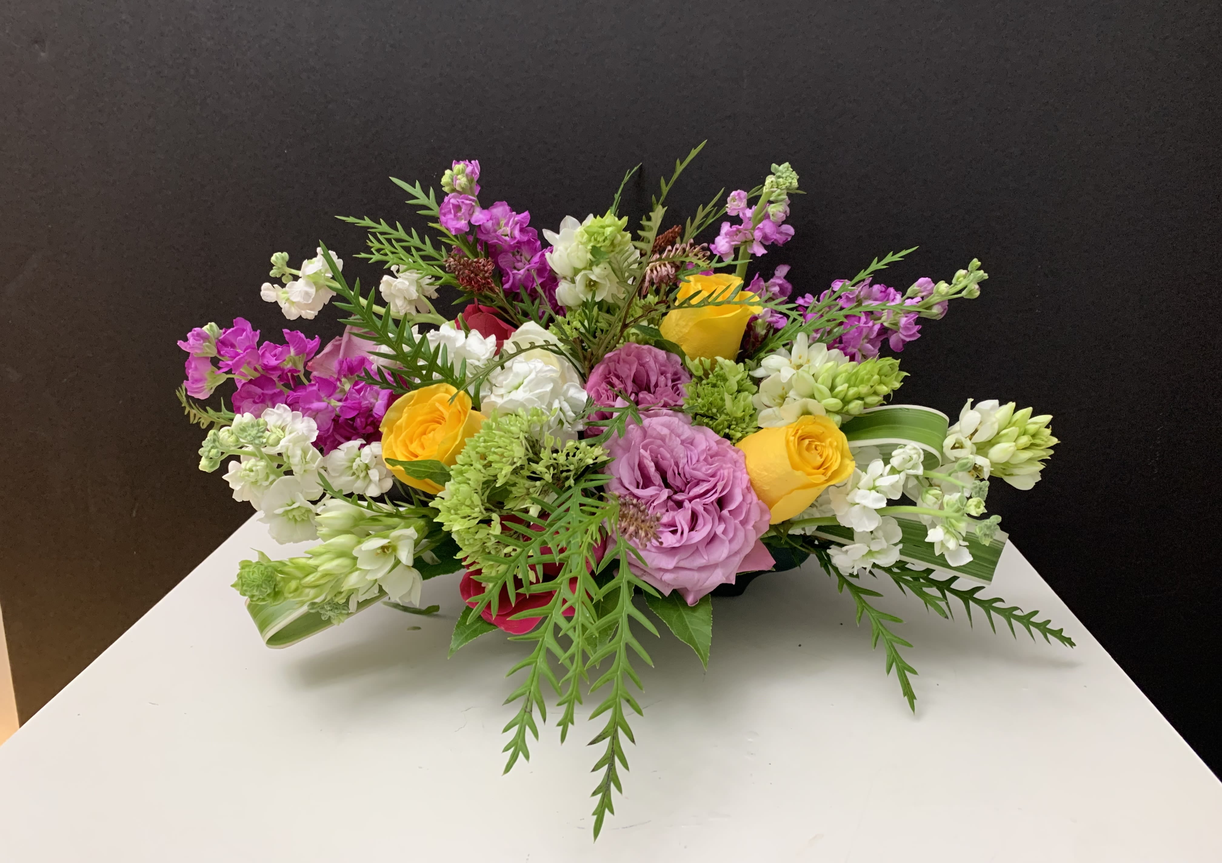 Mixed bouquet with pink, yellow, and white flowers on a table