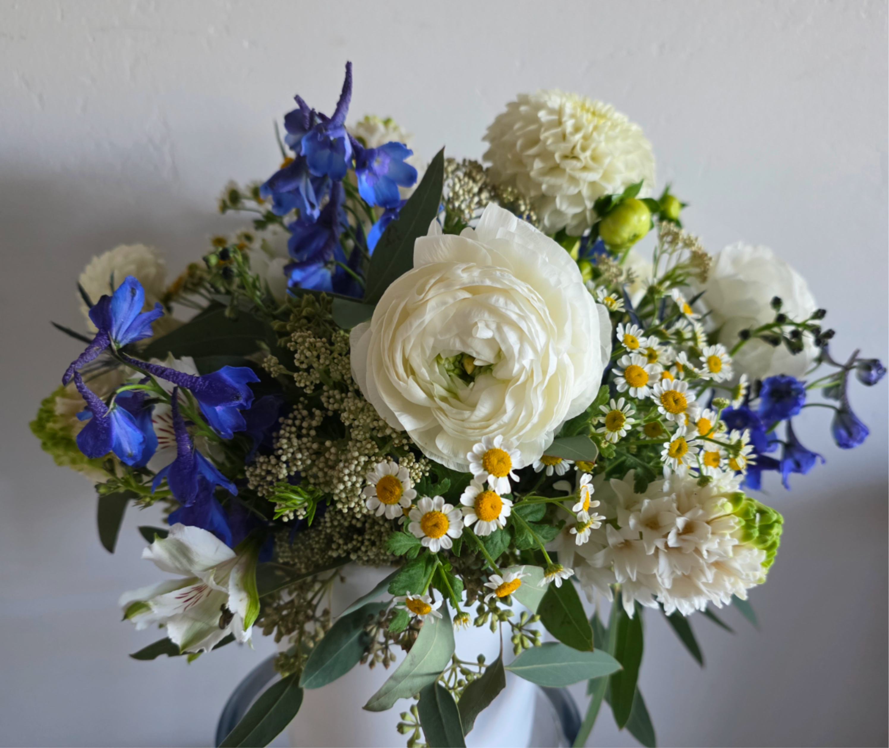 Bouquet of white and blue flowers in a vase