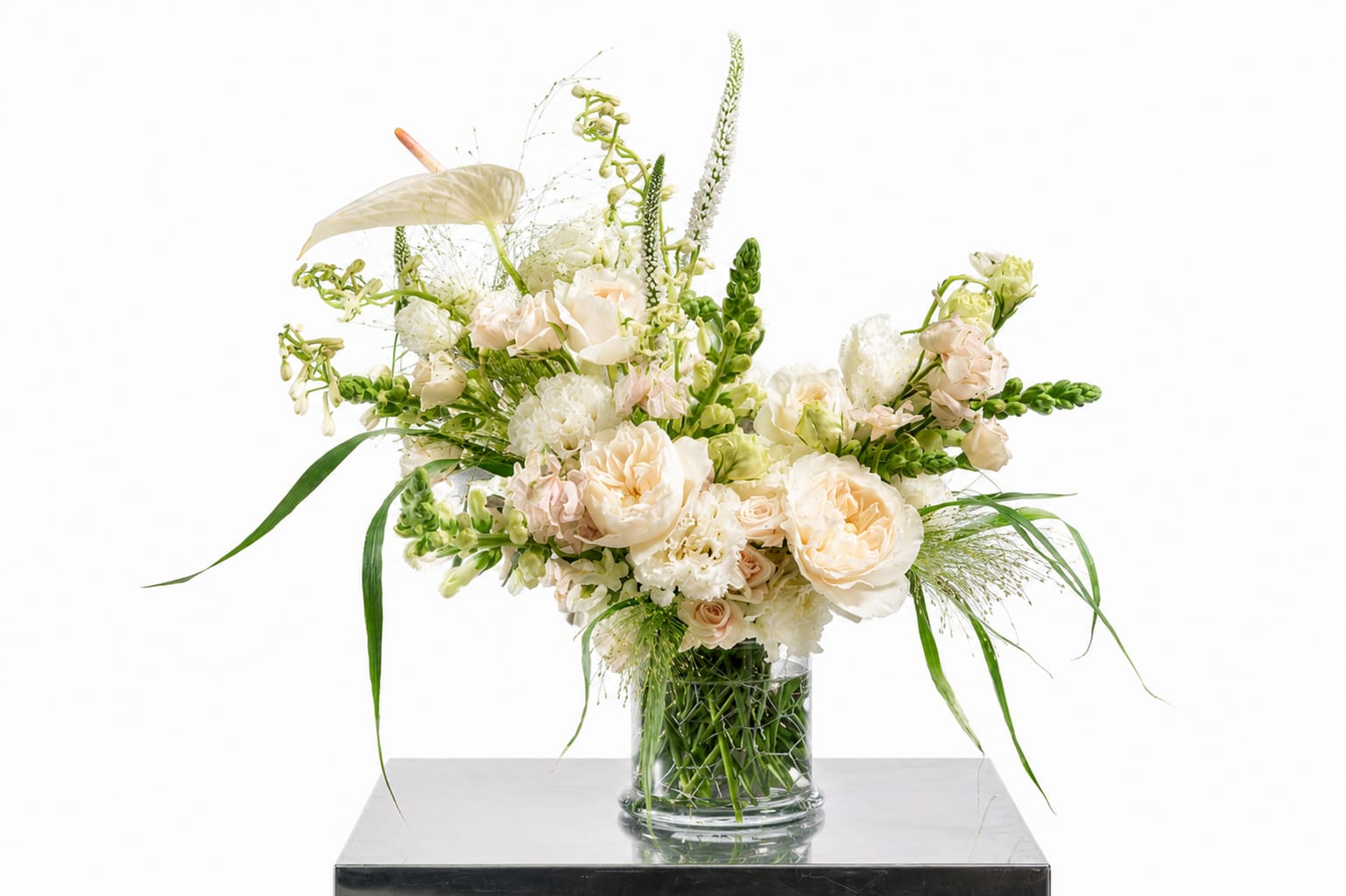 Cream and white floral arrangement in a clear glass vase