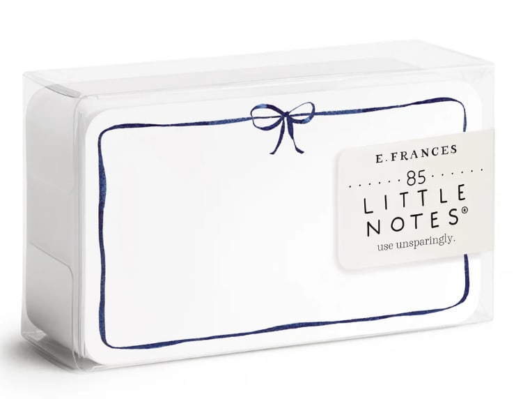 Boxed set of white note cards with a navy border and bow