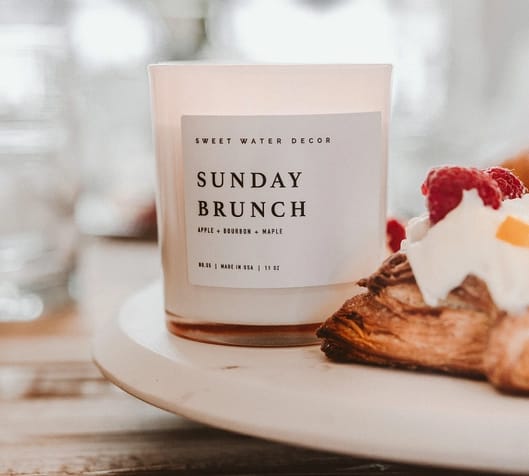 Sunday Brunch 11 oz Soy Candle - Description Our Sunday Brunch candle perfectly captures the sweet scent of apple and maple with balanced hints of bourbon and vanilla. Although considered more of a Fall fragrance, this can be enjoyed year-round. Be reminded of a sweet brunch and the cozy aromas it brings!  If your customer loves our sweet Sunday Brunch scent, they will also love our Farmhouse and Mulled Cider scents. Perfect for Fall, Thanksgiving, and Halloween (or when brunch is on your mind.)  Scent Notes: • Top: Apple, Cinnamon, Orange • Middle: Bourbon, Butter, Coconut • Base: Maple, Vanilla • Infused with natural essential oils: Tangerine and Mandarin  Candle Info: • Size: Volume 11oz | 214g Net Weight | 3x3x3.5" • Burn Time: 50+ Hours • Wick: 100% Cotton (Lead and Zinc Free) • Wax: Proprietary Soy Based Wax Blend | Vegan, Non-GMO, Kosher • Premium Fragrance Oil • Gluten Free, Phthalate Free, Non-Toxic • Made in Pittsburgh, PA