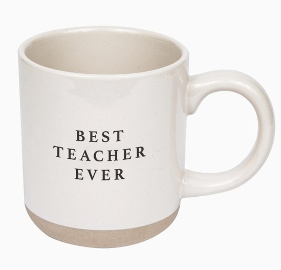 Best Teacher Ever Stoneware Coffee Mug - Description A teacher appreciation gift made for their favorite drink, our Best Teacher Ever mug is a great gifting option for back to school or the end of the school year. Add it to an end of school year or graduation display for gifting.  Pair it with our Best Teacher Ever candle for the perfect gift bundle.  DETAILS:  • 14oz Stoneware Style Mug • Size: 3.46 x 3.93" (5.19" w/handle) • Original Design: Best Teacher Ever • Design on Both Sides of Mug • Cream With Black Lettering • Speckled Design with Natural Bottom Details • Each piece is hand-crafted, making the character of each mug perfectly unique. There may be slight variations. • Designed in the USA, Imported