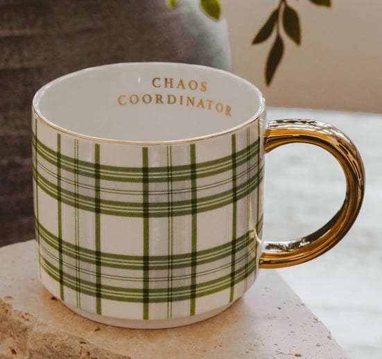 Chaos Coordinator Plaid 14oz Fine Bone China Mug - Description Bring a little joy to the busiest days with our Chaos Coordinator mug. The light blue and green plaid design adds a cheerful touch, while the gold text along the inner rim offers a playful reminder that you’re handling it all with grace. Perfect for morning coffee, afternoon pick-me-ups, or a well-earned moment of quiet, it makes a thoughtful gift for moms, teachers, and anyone who keeps life running smoothly.  Details:  • 14oz Fine Bone China • Size: 3.20" H x 3.75" W (5.45" w/ handle) • Original Design: Light Blue and Green Plaid • Design All Around Mug • Gold "Chaos Coordinator" Along Inner Rim • Real Gold Details on Rim and Decal • Stackable with other 14oz. Sweet Water Decor Gold Handle Mugs • The design printed on each mug may vary slightly from one mug to another • Designed in the USA, Imported