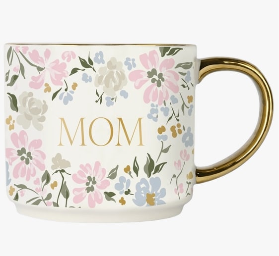 Floral Mom Coffee Mug - Description Offer a thoughtful Mother's Day gift with our Mom Mug, featuring beautiful gold foil details and stunning floral design. Perfect for new moms or those with older children, this mug adds a personal touch to their daily routine. A must-have addition to your gift or home décor collection.  DETAILS:  • 14 oz Fine Bone China • Size: 3.20" H x 3.75" W (5.45" w/ handle) • Original Design: Mom with Floral Design • Design All Around Mug • Gold Handle and Details • Stackable with Other 14oz Sweet Water Decor Gold Handle Mugs • The design printed on each mug may vary slightly from one mug to another • Designed in the USA, Imported