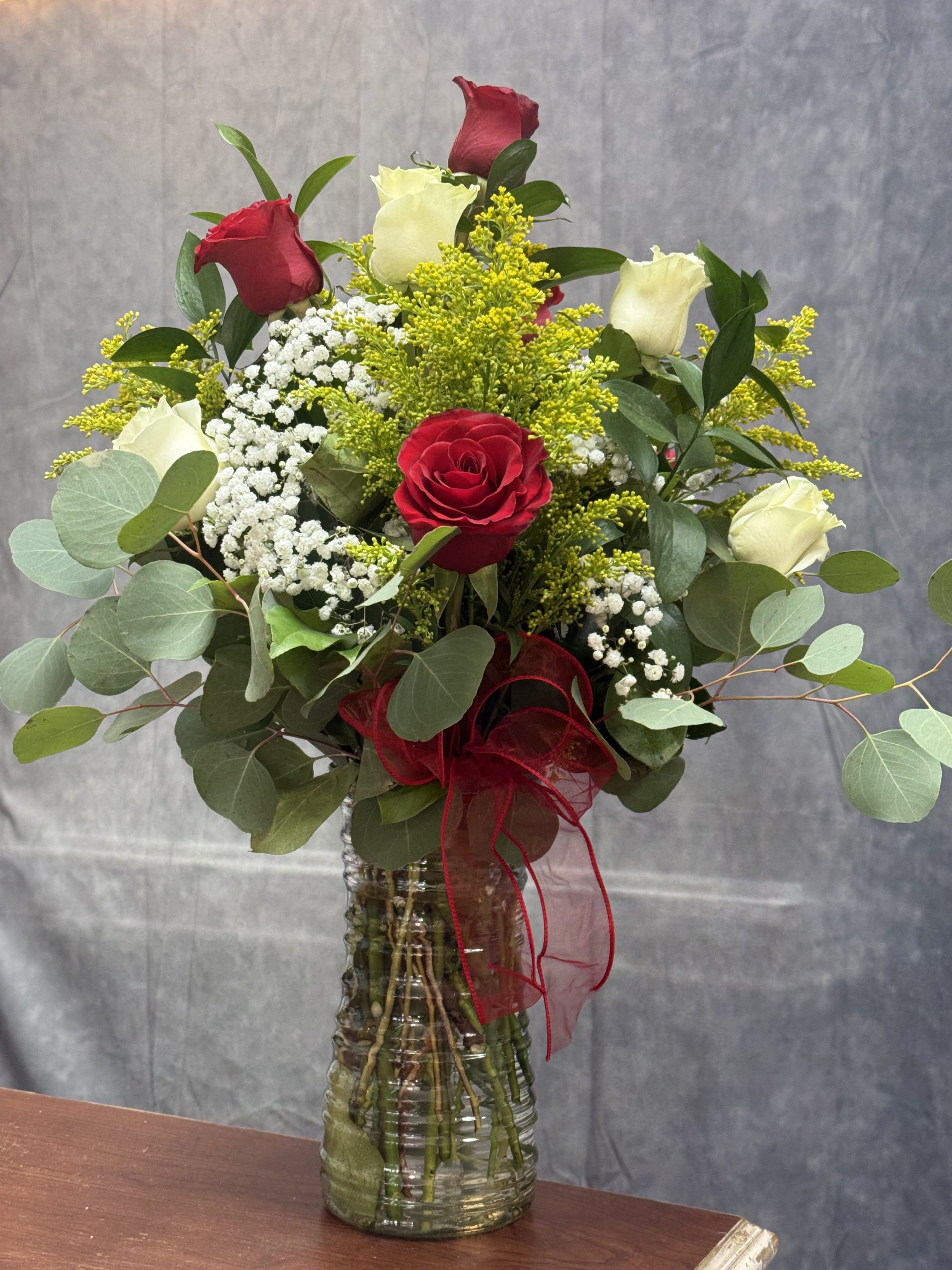 Red White Roses Vase - White &amp; Red Roses Vase A romantic blend of white and red roses, accented with baby’s breath and greenery in a classic red vase. A timeless way to say I love you or Happy Birthday.